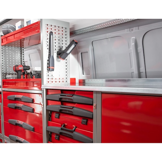 Facom U50020057 workshop storage with red drawers, black handles, and mounted tools, front angle.