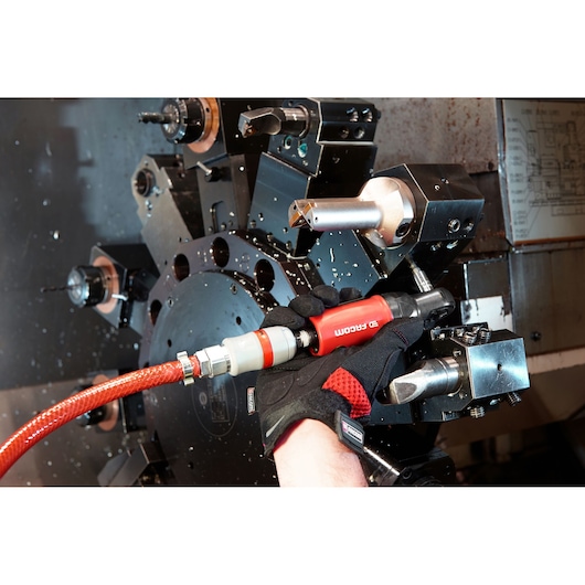 Facom VR.R127PB pneumatic tool in use near lathe machine, red and black handle, close-up photography.