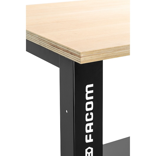 Photo of Facom WB2.2000W workbench corner, showing light wood top and black metal leg with Facom logo, angled view.
